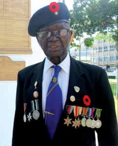 World War II veteran, Haynes Cyril, at the War Memorial in Derek Walcott Square. [Photo: Stan Bishop]