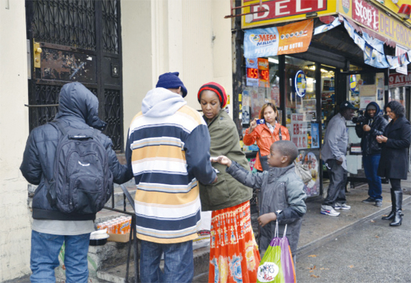 Carla St. Romain distributing food in Brooklyn.