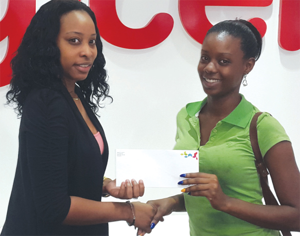 Lambert's grand daughter, Sharine Augustin (right) collects her winnings.