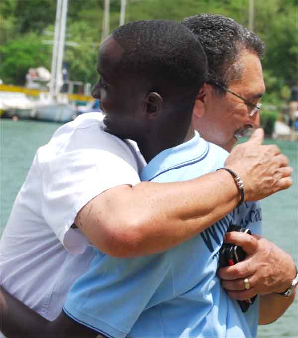 St. Lucia's Prime Minister Dr. Kenny Anthony gives Under - 15 captain Kimani Melius a huge hug for his success. [Photo: Anthony De Beauville]