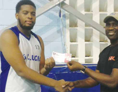 Image: Combined Schools Parkel Gumbs who scored 14 points, 7 rebounds receiving his KFC Player of the Game award from SLBF PRO Neil Joseph.