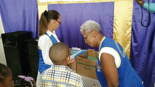 Kiwanis President Louise Vite’ presenting supplies to a student from the Guesneau community.
