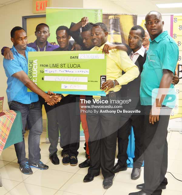 Image: Micoud coach Cornelius Butcher receiving the $25,000.00 cheque from LIME Representative Kissinger Anthony. (Photo Anthony De Beauville)