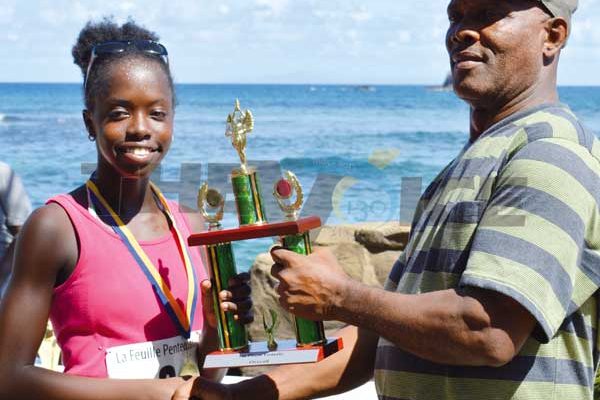 ThomykaValcent receiving her 1st place trophy from Pastor Lennox Maxius. (Photo Anthony De Beauville)