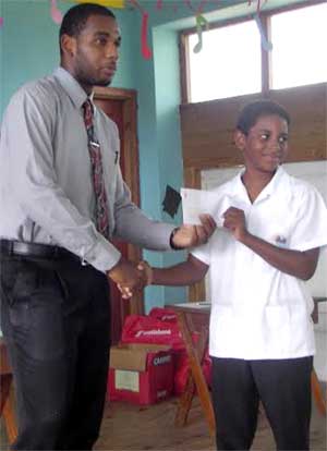 Image: August gets a grant from Scotiabank’s Augustinus Andrew
