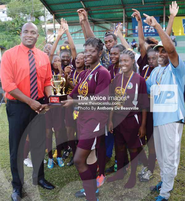 Image: Minister for Youth Development and Sports Shawn Edward presenting the inaugural championship trophy to Soufriere captain No.4 Nicole Montoute. (PHOTO: Anthony De Beauville)