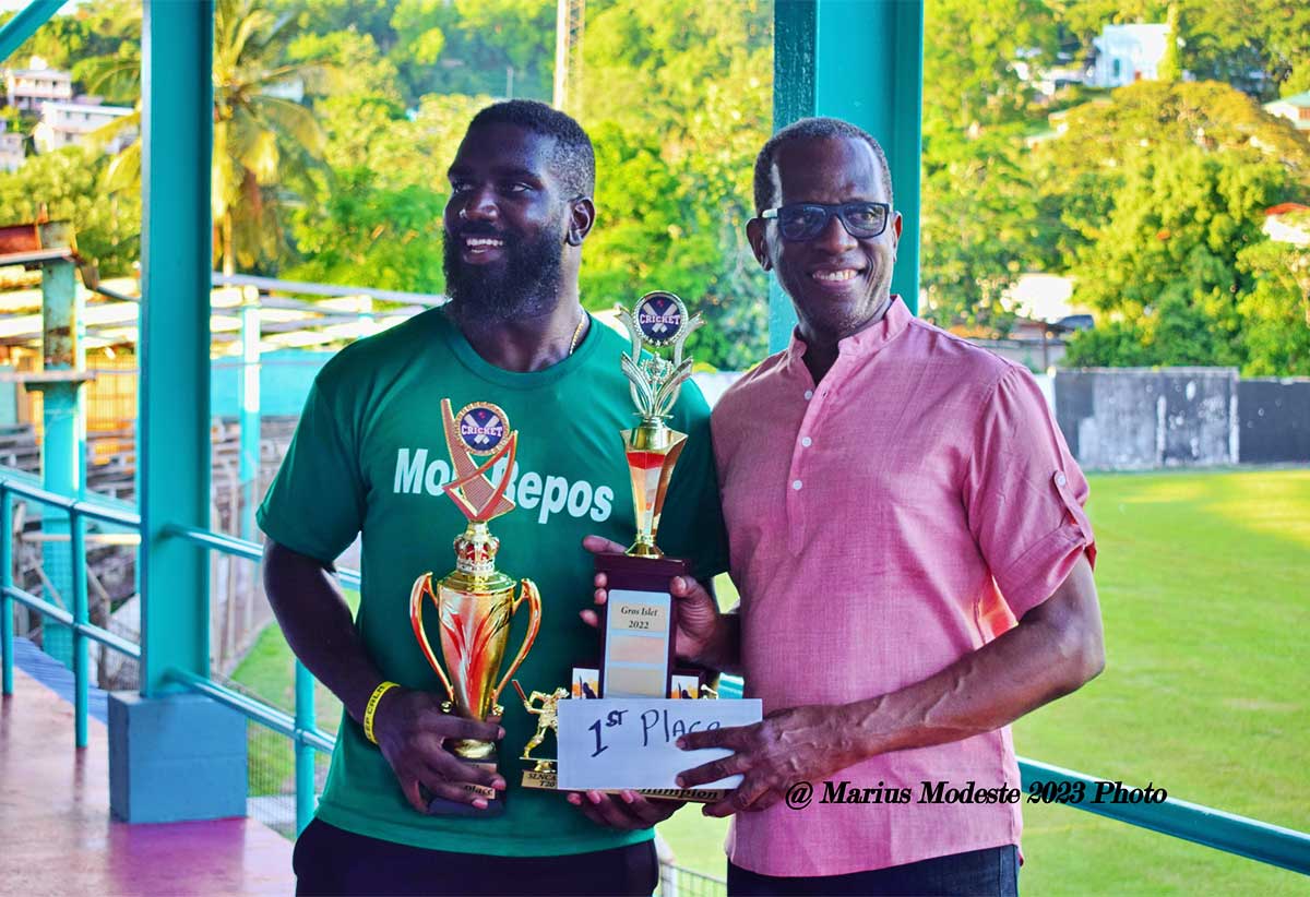 Mon Repos skipper Christian Charlery displays prize trophy with PM Pierre.