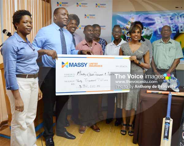 Minister for Youth Development and Sports receiving a $30,000.00 sponsorship cheque from Massy United General Manager Faye Miller, while members of staff from the Ministry, Massy United and SLNCA look on. [PHOTO: Anthony de Beauville]