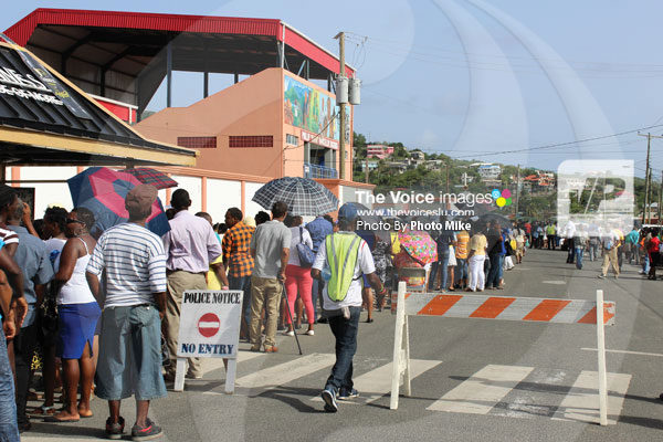 img This was the scene outside the Phillip Marcellin Grounds Tuesday afternoon for the swearing in of the Cabinet of Ministers. The event was open to the public however, those without a special invitation, had to form a line for orderly entry into the mini-stadium. (Photo by Photo Mike)