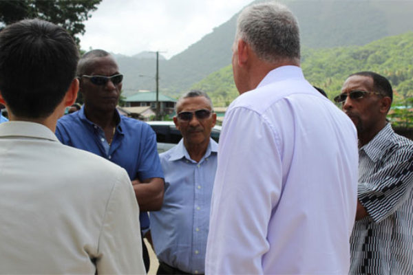 Image: Chastanet (R) and Taiwanese Ambassador, Ray Mou (back to camera) in conversation with some members of the Board of the Directors of the Soufriere Development Foundation near Hummingbird Beach Thursday.