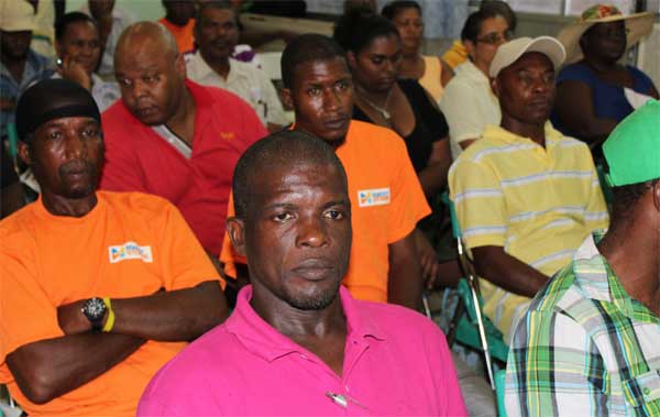 Image: Farmers listening to Massy officials.