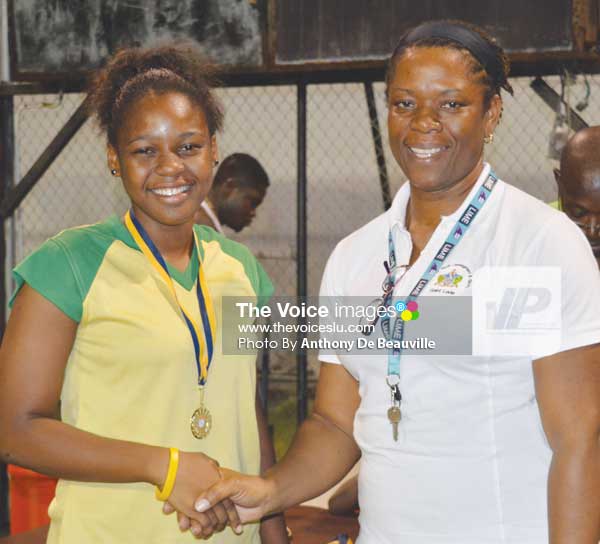 Image: (L-R) SALCC Jedda Alcee receiving her gold medal from School Sports Coordinator Isabelle Marquis following the Secondary Schools Volleyballs finals between SALCC and SJC (Photo: Anthony De Beauville)