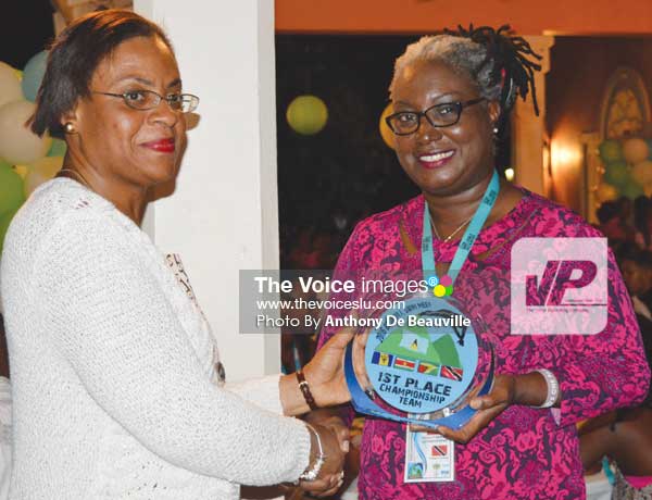 Image: (L-R) SLASA President Carol Mangal presenting Trinidad and Tobago Team Manager with 1st Place Championship Trophy. (Photo Anthony De Beauville)