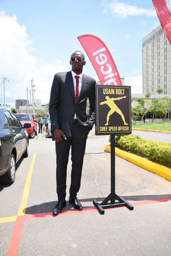img: Usain Bolt, Digicel’s Chief Speed Officer (CSO), checks out his designated parking slot on his first day at work at the Digicel regional HQ.