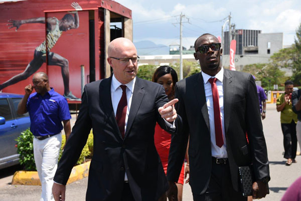 img: David Butler, Digicel Jamaica CEO, welcomes Usain Bolt, Digicel CSO, to work on his first day.