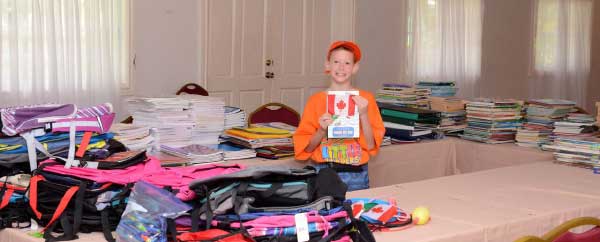 Image: Noah shows off the bounty of school supplies