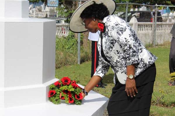 Image: Governor General Dame PearletteLouisy laying a wreath at the War Grave at Choc Cemetery.