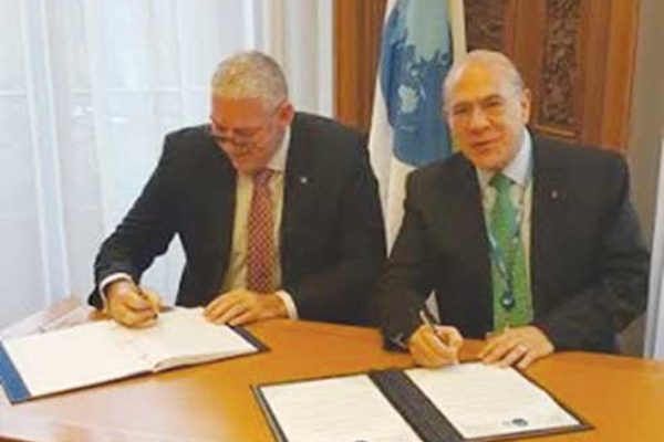 Image: Prime Minister Chastanet signing the agreement in Paris