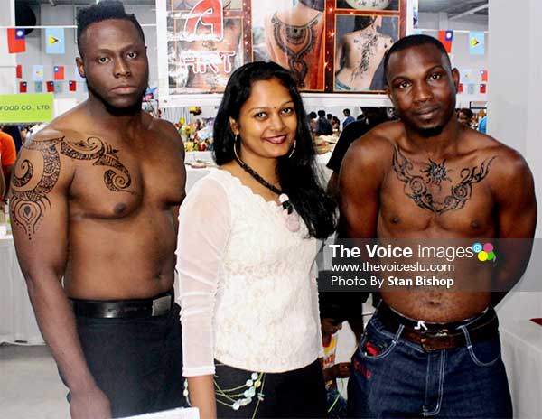 Image: Heera Patra (centre) with two models showcasing her henna art at a recent exhibition. [PHOTO: Stan Bishop] 