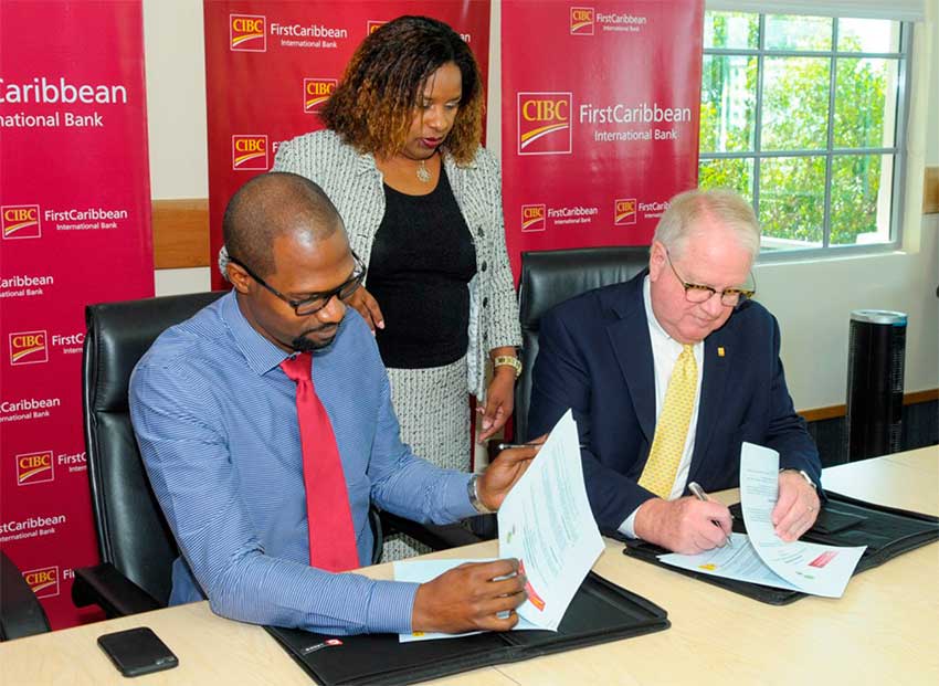 Image: Brown and Selwyn Cambridge sign the agreement.