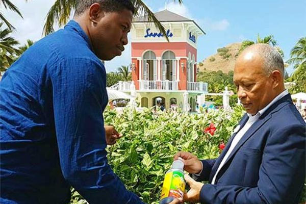 Image: Dujon (left) tells Sandals Grande GM Winston Anderson about his product.