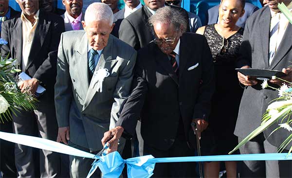 Image: The symbolic ribbon cutting was performed by two founding fathers of the St. Lucia Co-operative League, namely Emmanuel Theodore (L) and Haydn Williams. [PHOTO: By PhotoMike]
