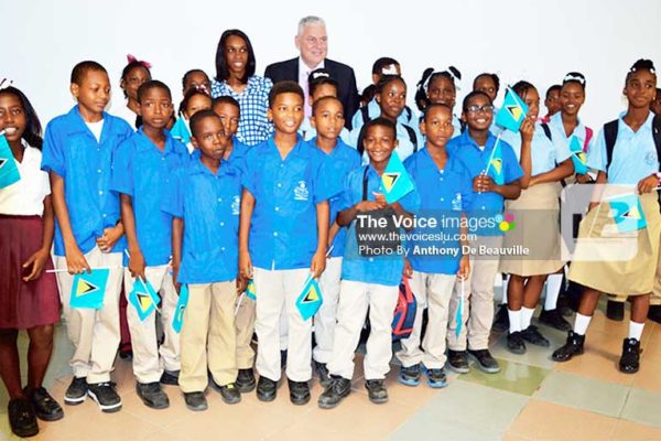 Image: Prime Minister Chastanet (in back row) with three-time Olympian Levern Spencer and students at the official opening ceremony.(Photo: Anthony De Beauville)