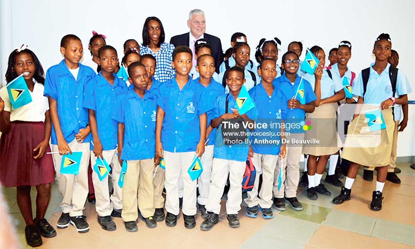 Image: Prime Minister Chastanet (in back row) with three-time Olympian Levern Spencer and students at the official opening ceremony.(Photo: Anthony De Beauville)