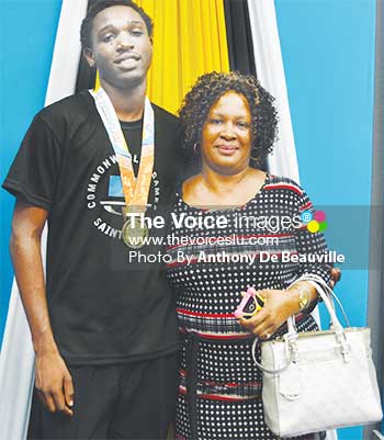 Image of Saint Lucia’s lead goal scorer (7) Linus Clovis shares a photo moment with his mother, Lindel Clovis. (PHOTO: Anthony De Beauville)