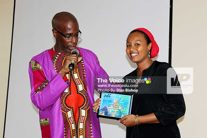 Image: Poet and activist, Xylaw, receives a plaque of recognition from Herman.