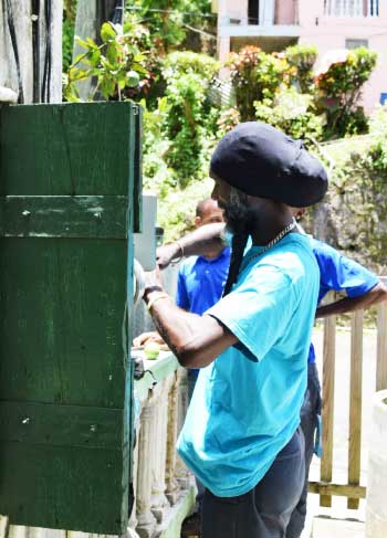 Image of Flow technicians at work in the community of Fond St. Jacques.