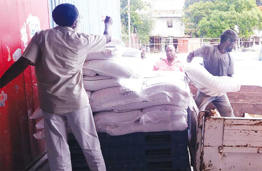 Image of sugar being loaded for distribution