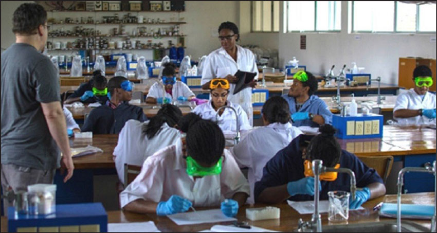 img: Dr. Tony Rossomando with students in Biochem Lab.