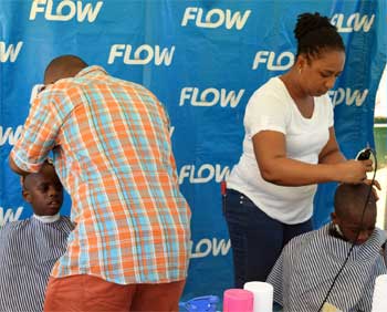 Image: Boys were able to get free haircuts and girls got their hair braided at the Flow back-to-school fair.