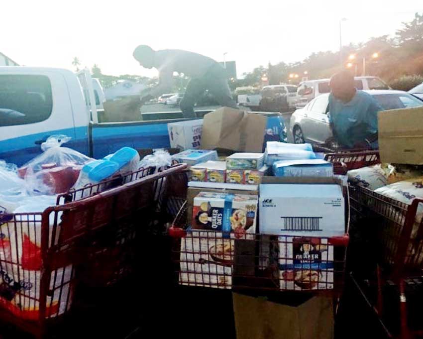 Image: Team Flow Saint Lucia working to load supplies for Dominica.