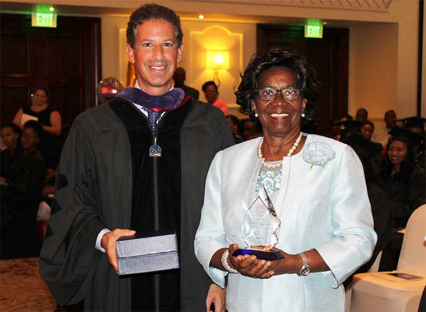 Image: Monroe College President, Marc Jerome, presents Dame Pearlette with a plaque of appreciation.