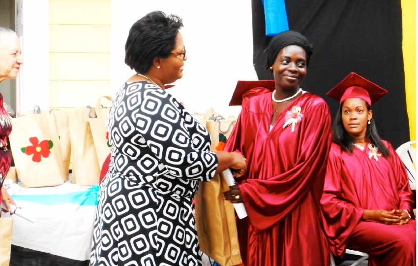 Image: A graduate receives her certificate.