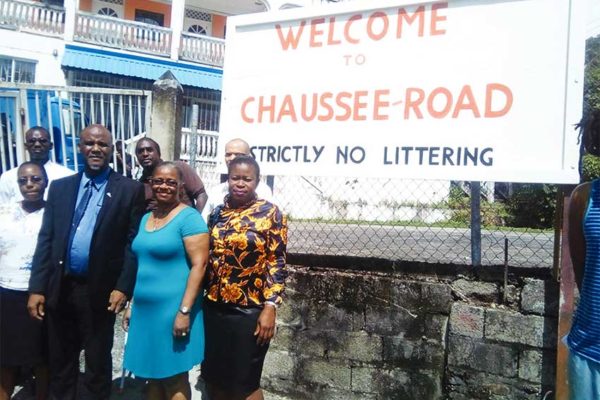 Image of Mayor Francis and members of CROBA in front the billboard placed at a spot where garbage once dominated.