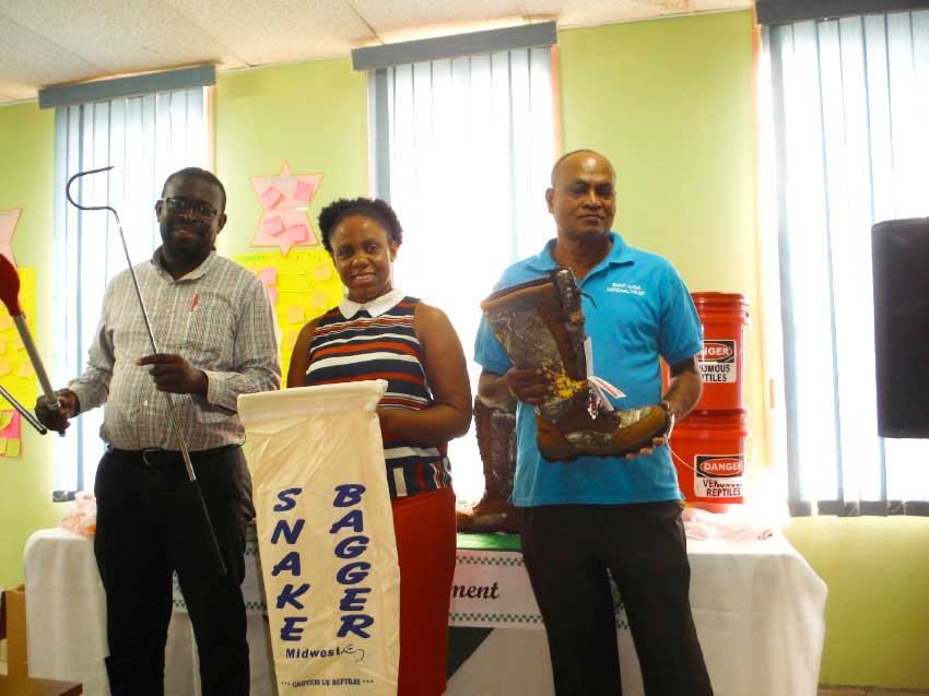 image: SLNT and Forestry Division reps displaying some of the new equipment.