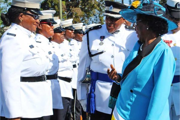 Image: Dame Pearlette chatting with a female police officer on parade accompanied by Assistant Commissioner of Police Frances Henry, the highest ranking female officer of all time in the police force who sometimes wears the hat of acting Deputy Police Commissioner. (PHOTO: PhotoMike)