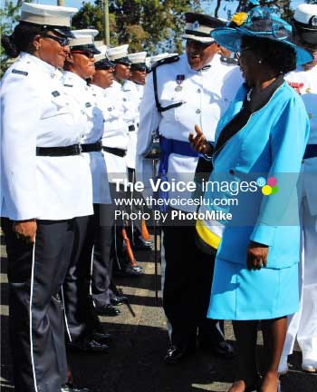 Image: Dame Pearlette chatting with a female police officer on parade accompanied by Assistant Commissioner of Police Frances Henry, the highest ranking female officer of all time in the police force who sometimes wears the hat of acting Deputy Police Commissioner. (PHOTO: PhotoMike)