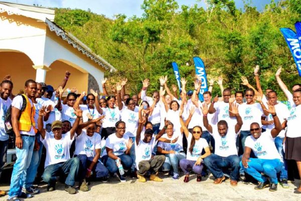 Image: Mission Accomplished! C&W CEO John Reid celebrates with members of his executive team and the colleagues of Flow Dominica on the completion of their Mission Day 2017 Volunteer activity in Dominica at CHANCES.