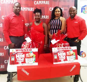 Image of Campari Brand Manager Denver Alcee (left) and Dexter Percil, Sales and Marketing Manager, PCD (right), with the two lucky Campari Road To Trini Carnival 2018 winners.