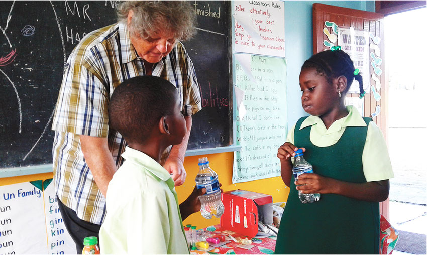 Image: Dentist Neil giving students a reminder on how best to brush the teeth.