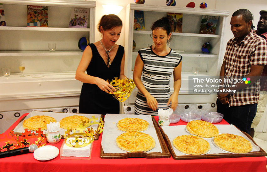 Image: Two Alliance Francaise staffers, left, share the Gallet de Rois. [PHOTO: Stan Bishop]