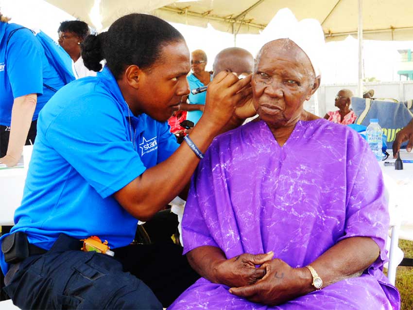 Image of An elderly woman having her ear tested.