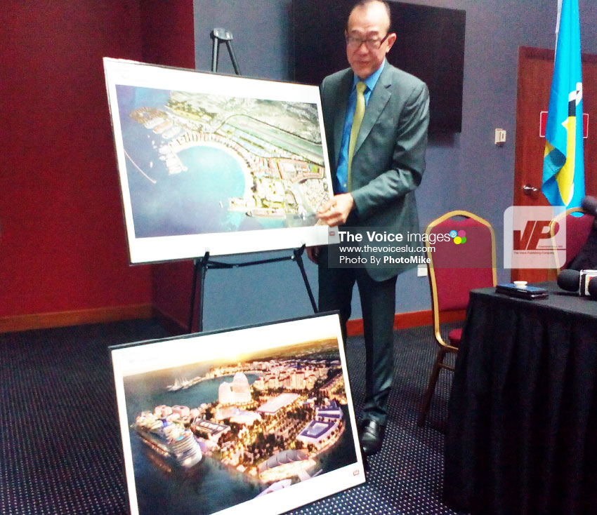 Image of Ah Khing presenting pictorials of what the Il Pirata site will look like after completion of that phase of the Pearl of the Caribbean project. (PHOTO by PhotoMike)