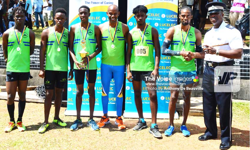Image: Champion team, The Road Busters presented wih their award by a representative of the RSLPF Micoud Division. (PHOTO: Anthony De Beauville)