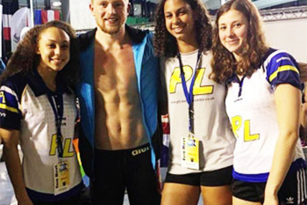 Image of Katie Kyle (third from left) with Great Britian medallist Adam Peatty