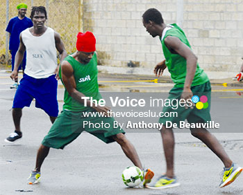Image: Despite the wet slippery conditions the players showed off their football skills. (PHOTO: Anthony De Beauville)